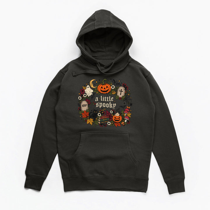 A black pullover hoodie with a festive Halloween graphic on the chest featuring pumpkins, ghosts, a moon, and the text 'a little spooky' in white, shown against a plain white background.